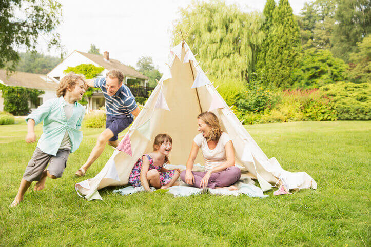a family camping and playing games in the garden