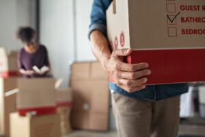 hands holding a cardboard box during a relocation